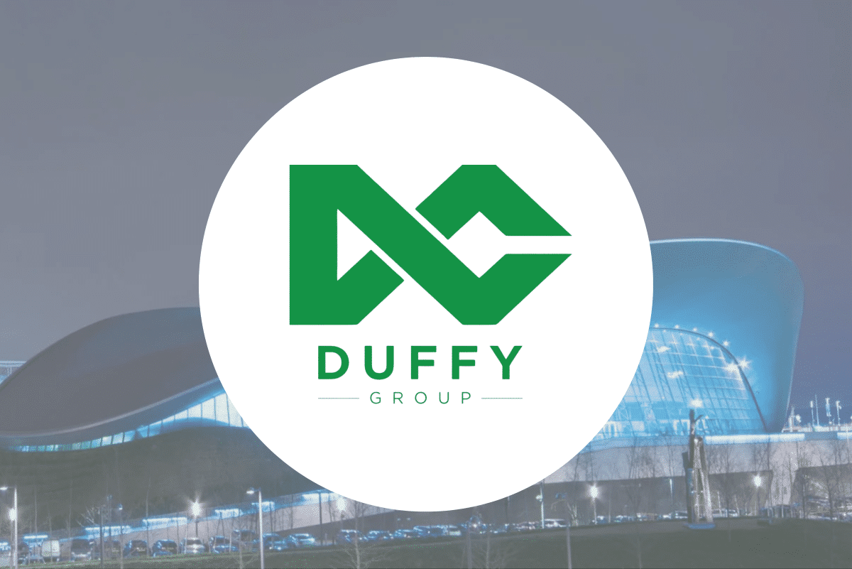 DuffyGroup Green Duffy Group logo on a white circle over a modern building background.