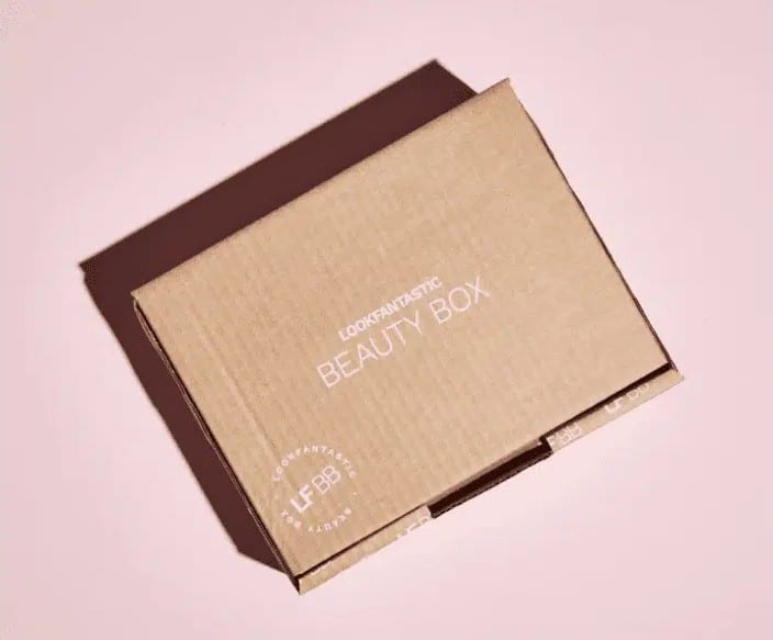 A cardboard LookFantastic Beauty Box on a pink background.